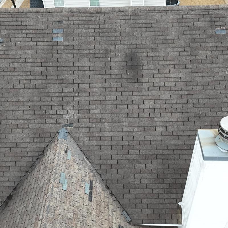 Three-tab shingle roof with eight missing shingles visible