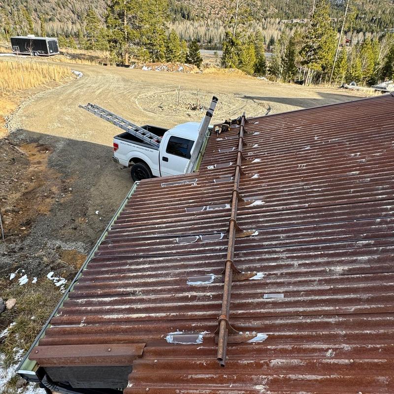 Corrugated corten metal roof with patch repairs
