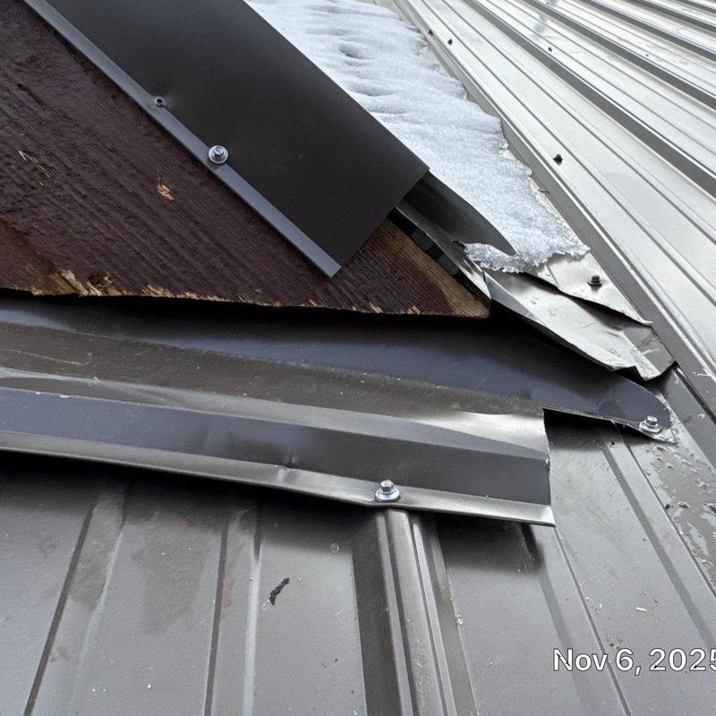 Metal roof panels and flashing with damage and repairs