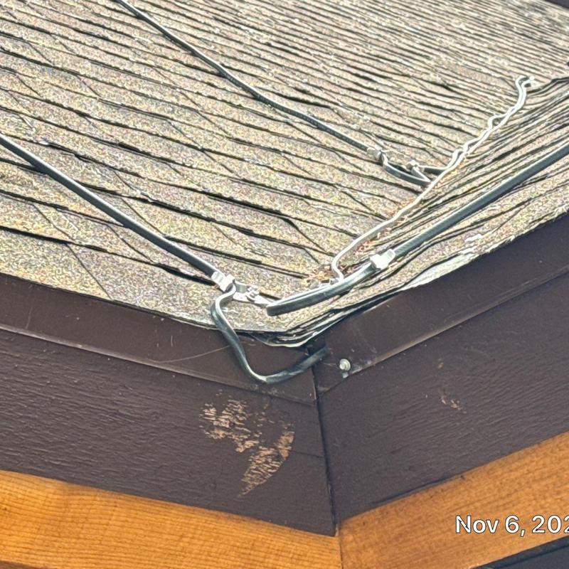 Asphalt shingle roof corner with heat tape wiring