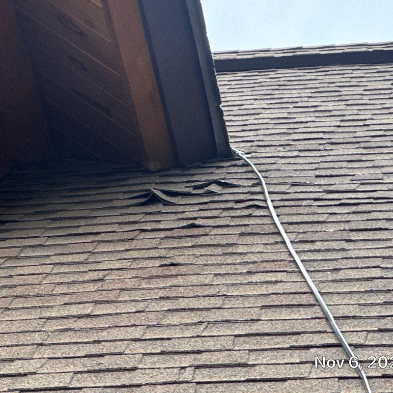 Asphalt shingle roof with lifted shingles and heat tape wire