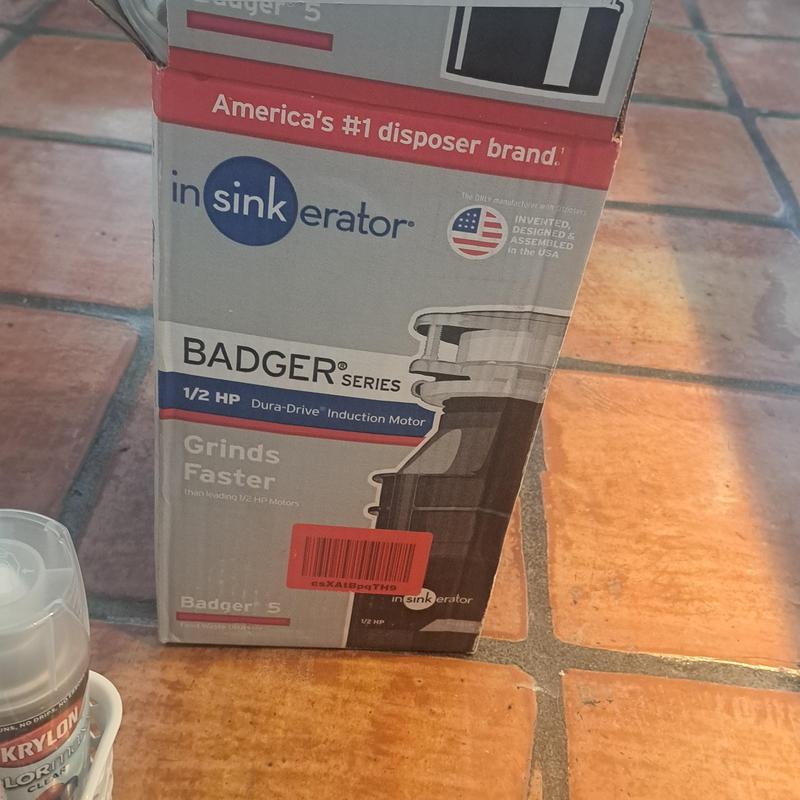 Garbage disposal Badger 5 box on tile floor
