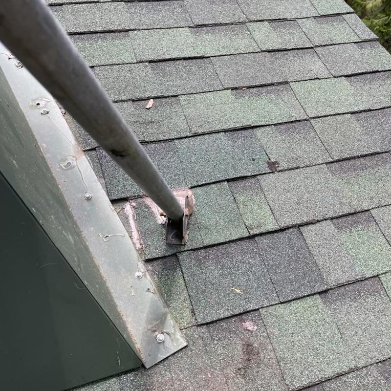 Roof pipe flashing with replaced shingles and braces