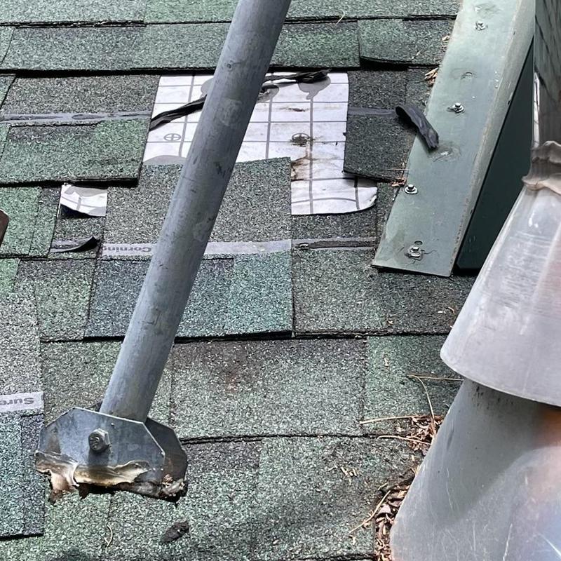 Roof pipe flashing with replaced shingles and braces