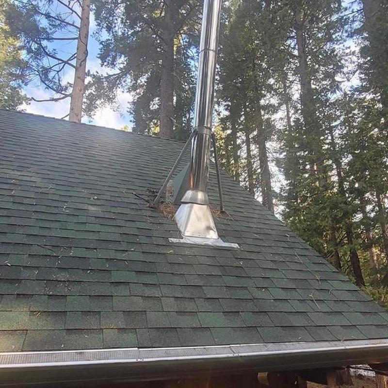 Metal roof pipe flashing with braces and shingles