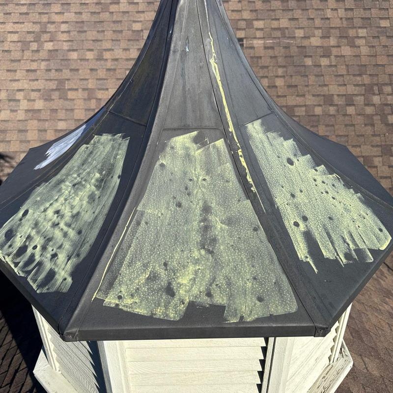 Metal turret roof hail damage marked for repair