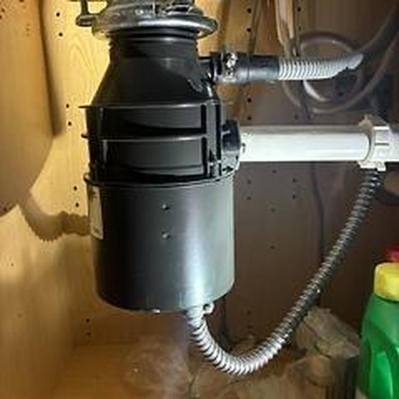 Garbage disposer under sink with plumbing connections