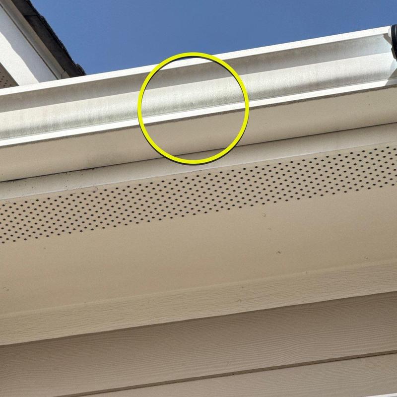 Gutter system showing hail damage on edge flashing