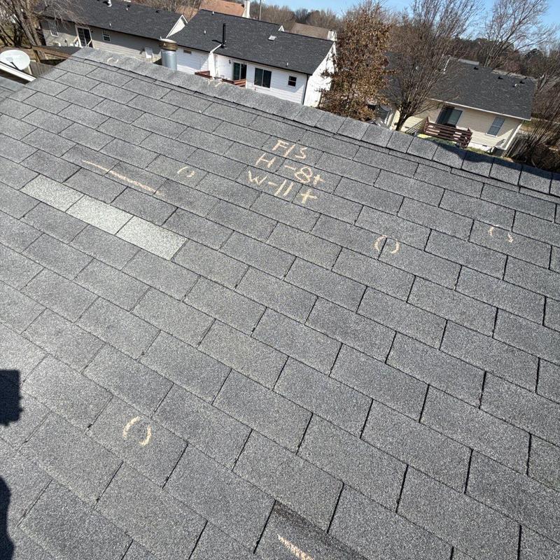 Asphalt shingle roof with hail damage markings