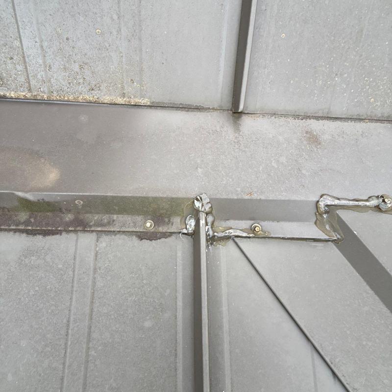 Standing seam metal roof ridge cap and flashing seal