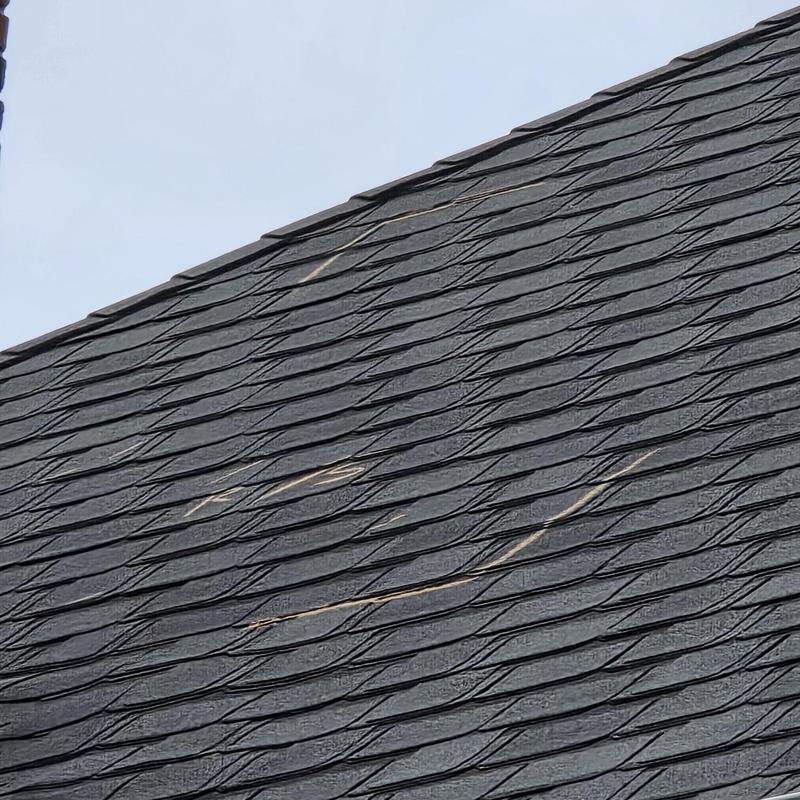 Asphalt shingle roof with hail damage marks