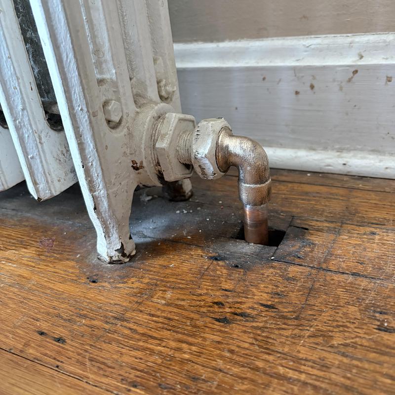 Cast-iron radiator copper return pipe with 90 elbow replacement