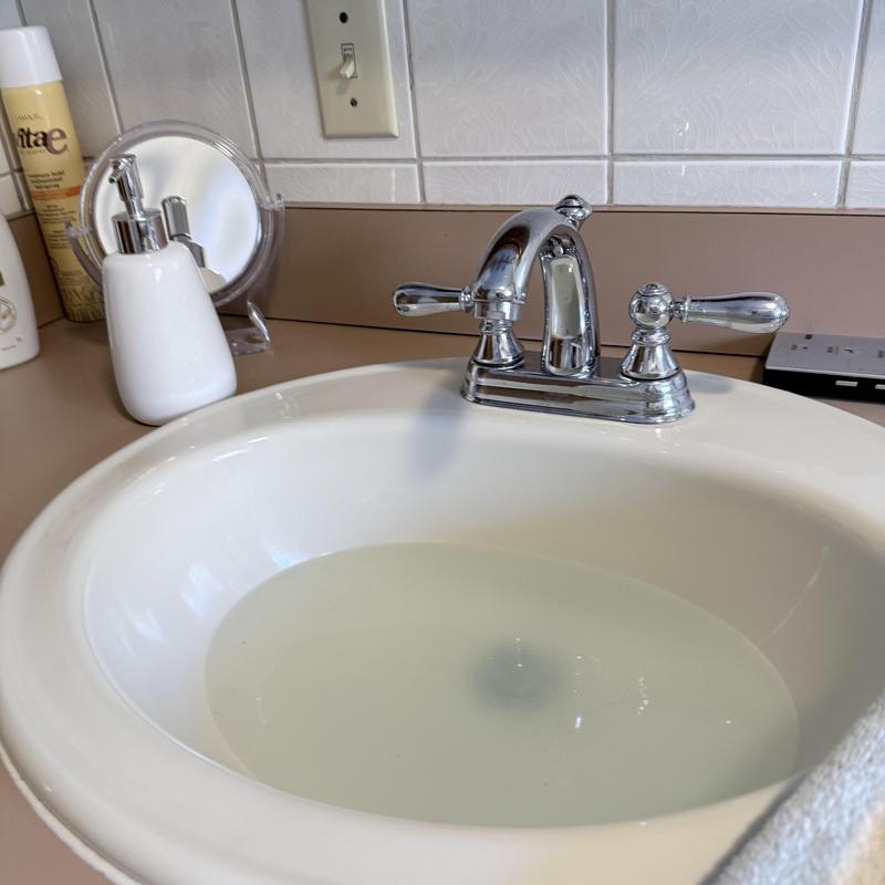 Lavatory basin with slow draining water and faucet Lavatory basin with slow draining water and faucet