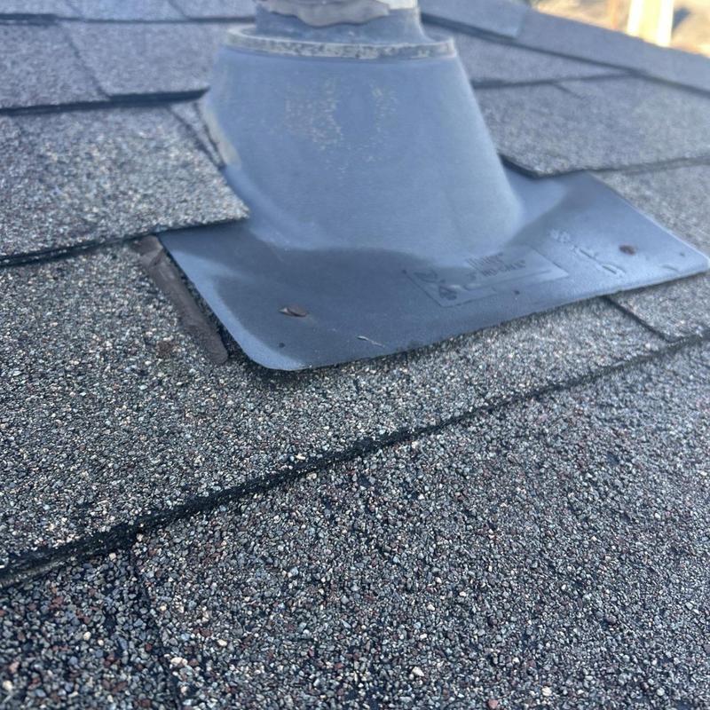 Roof pipe boot flashing with lifted shingles