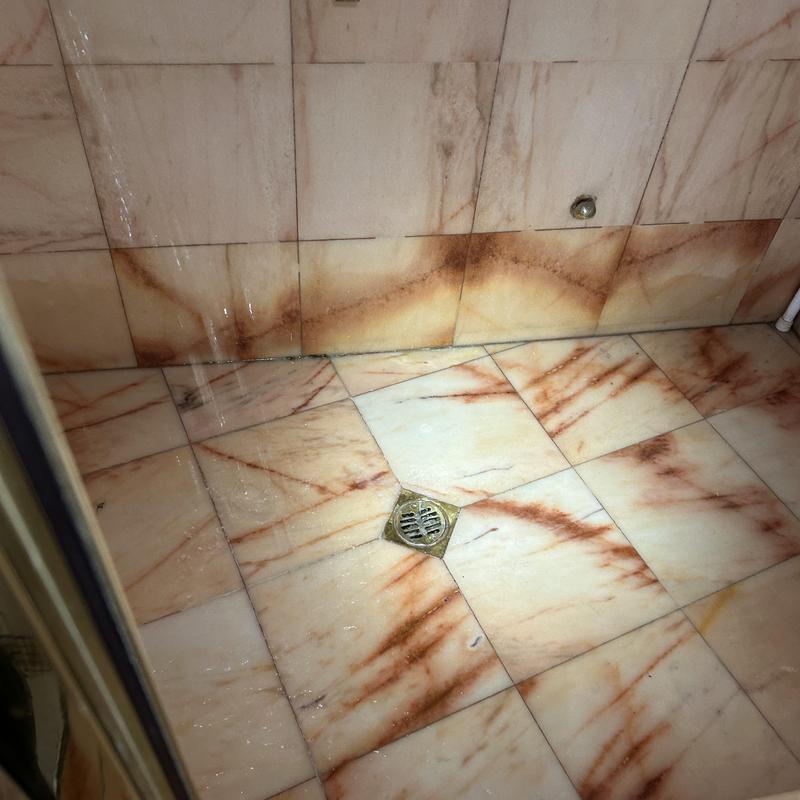 Shower drain and tile floor with metal drain cover