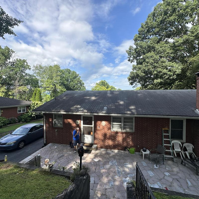 Asphalt shingle roof on brick house before replacement