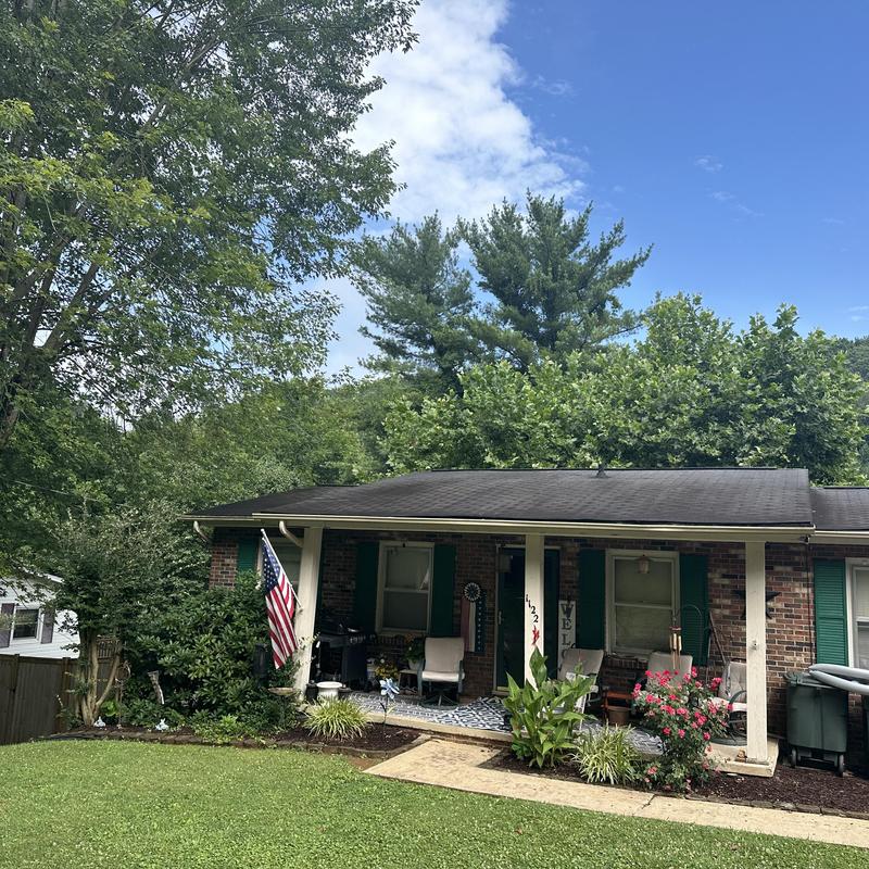 Shingle roof with gutters on brick ranch house