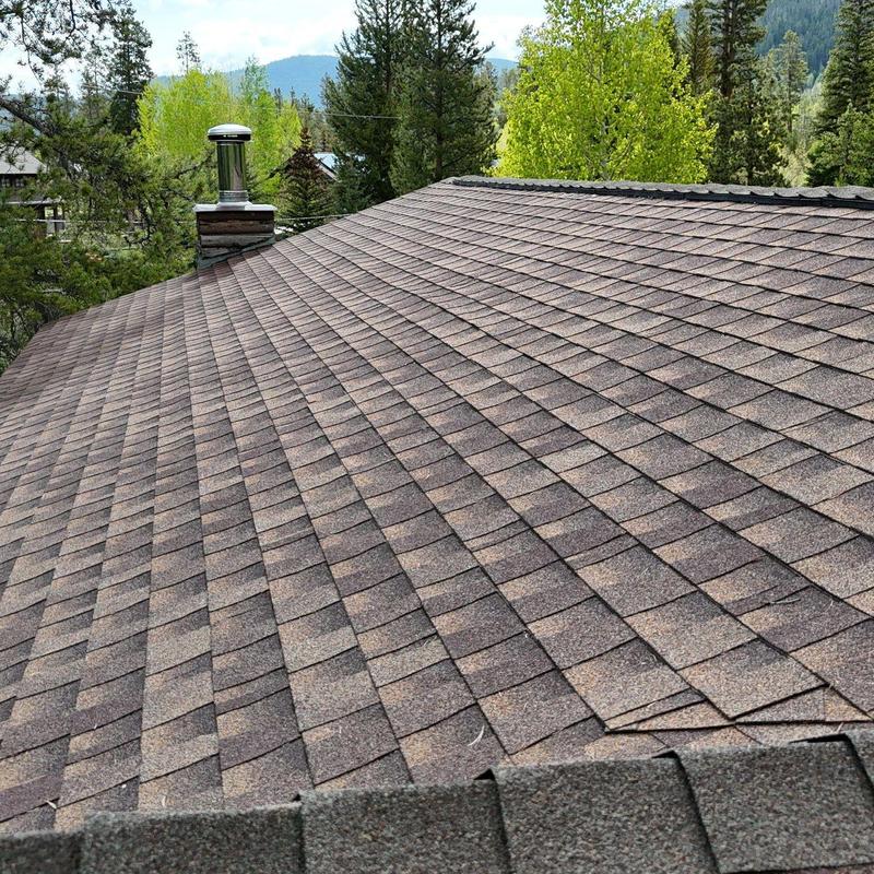Asphalt shingle roof with vent pipe and chimney
