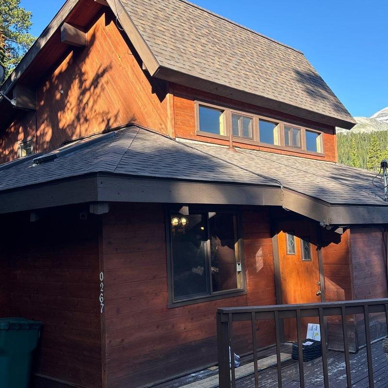 Asphalt shingle roof with heat tape and flashing