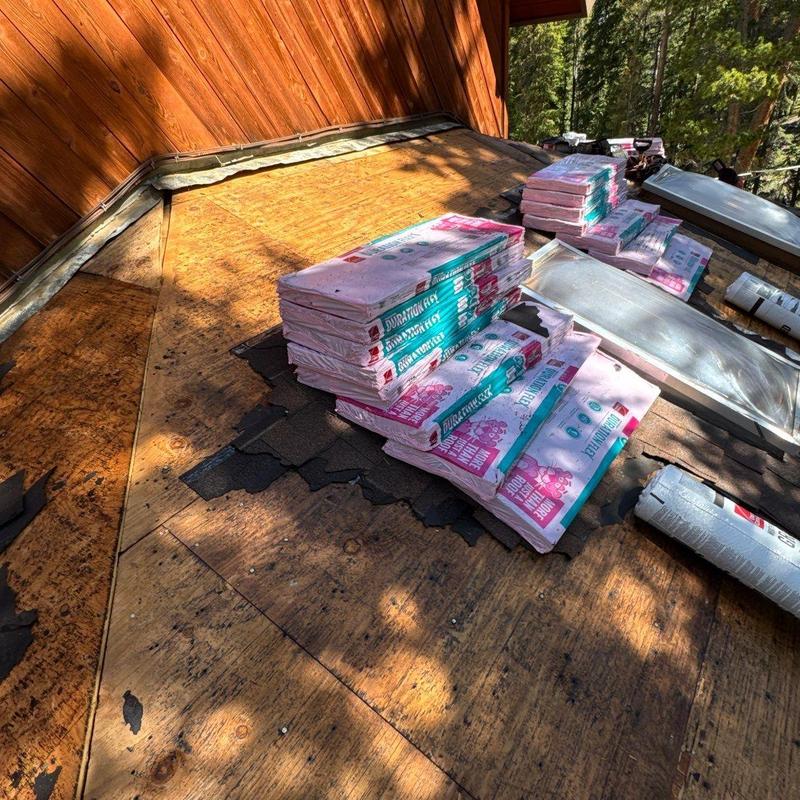 Asphalt shingle bundles on roof deck for replacement