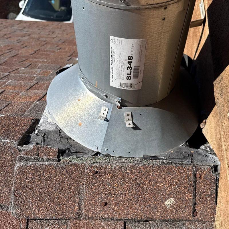 Asphalt shingle roof vent flashing with sealant damage