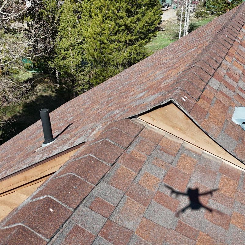 Asphalt shingle roof with ventilation pipe and missing shingles