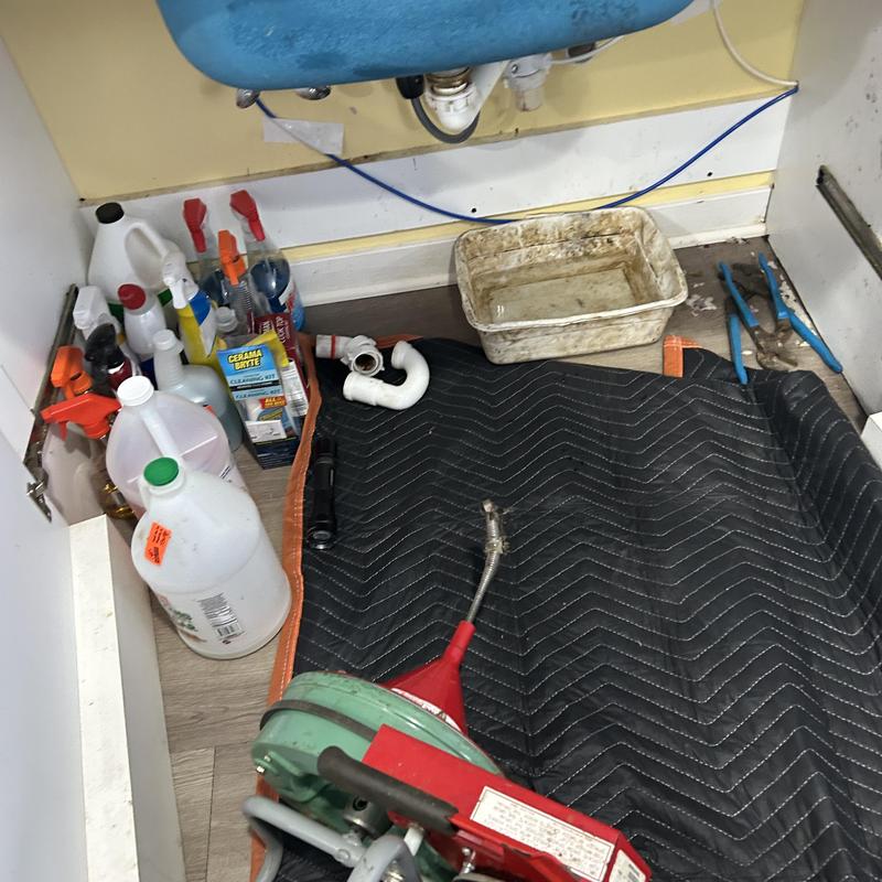 2-inch drain line with plumbing tools under sink