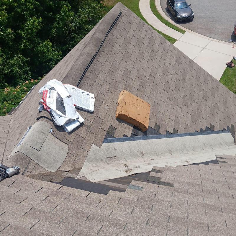 Roof valley with underlayment and roofing materials