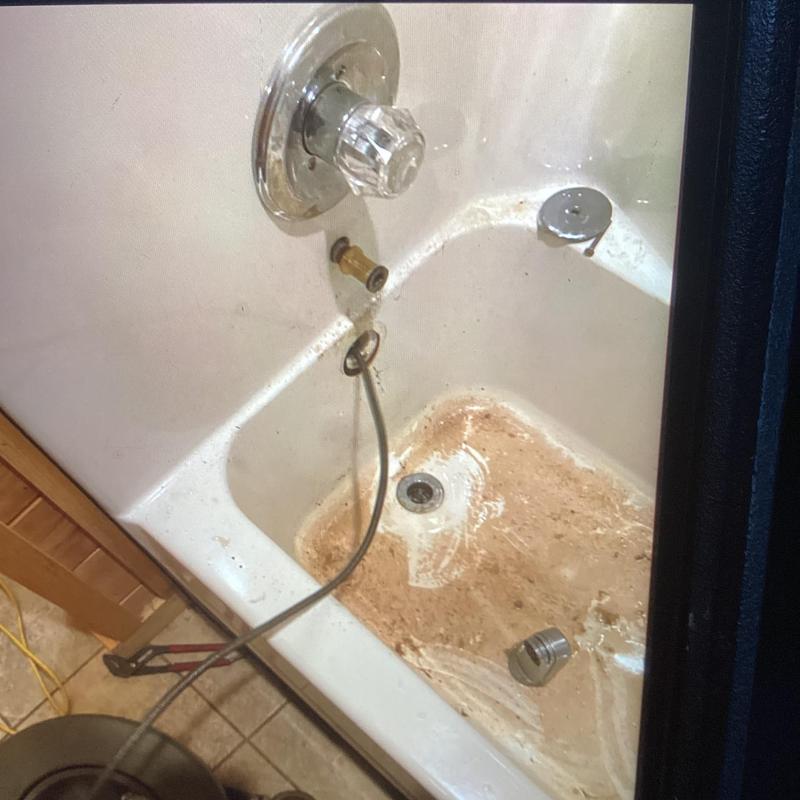 Bathtub drain blockage clearing with drain snake tool