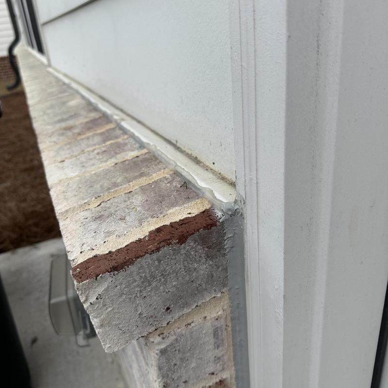 Brick door flashing with sealant on brick ledge