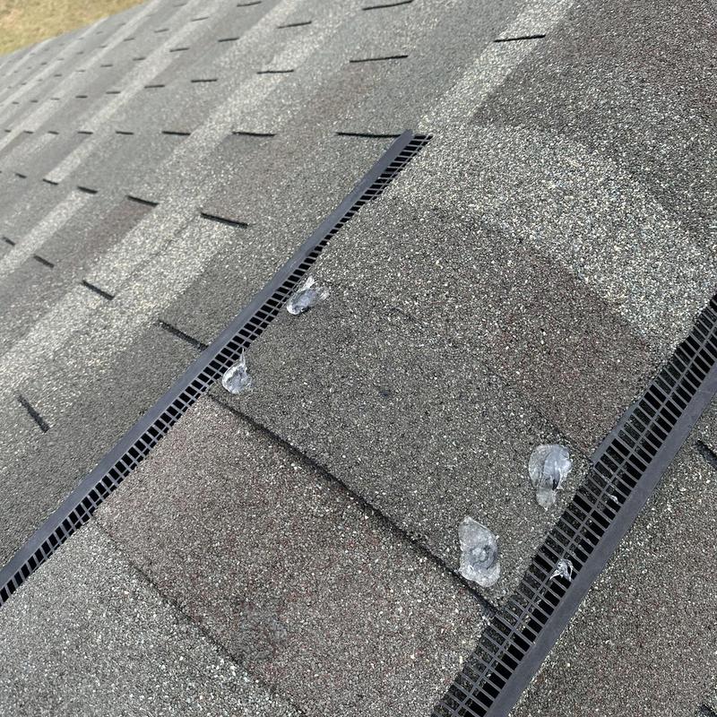 Roof shingle sealant on exposed ridge cap nails
