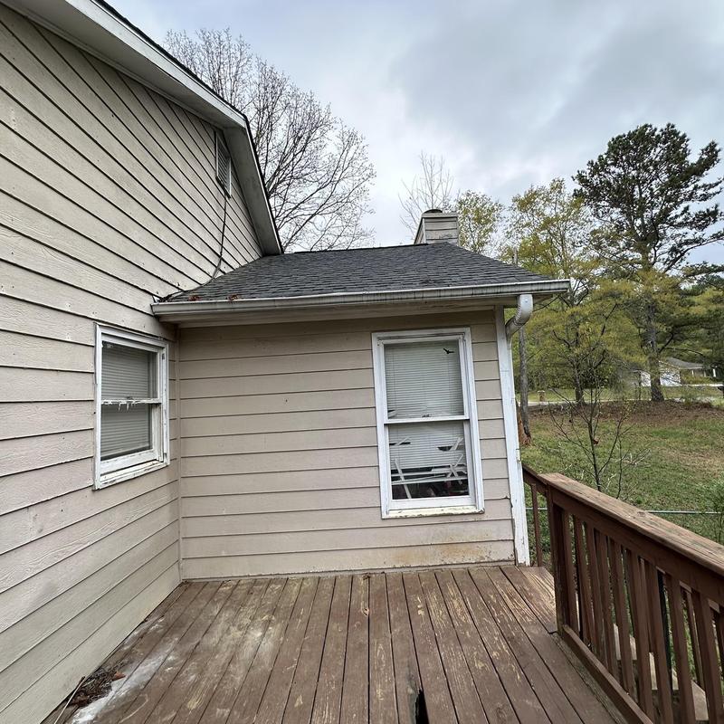 Steel gutter and downspout system rusting on house exterior