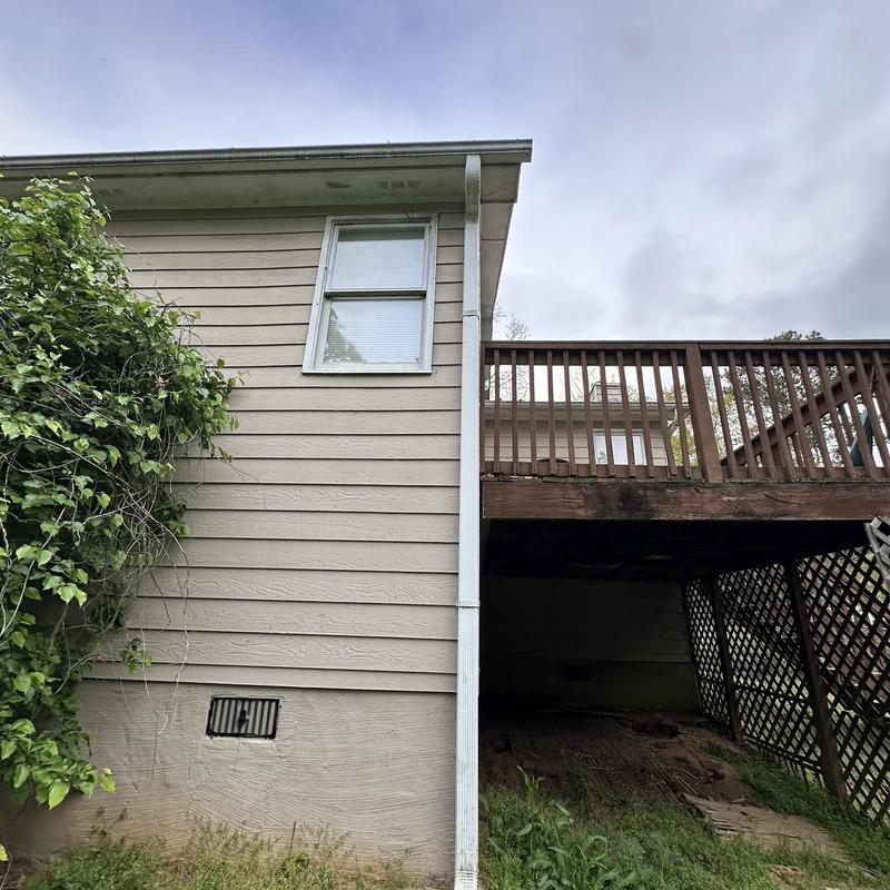 Steel gutter and downspout system with deck above