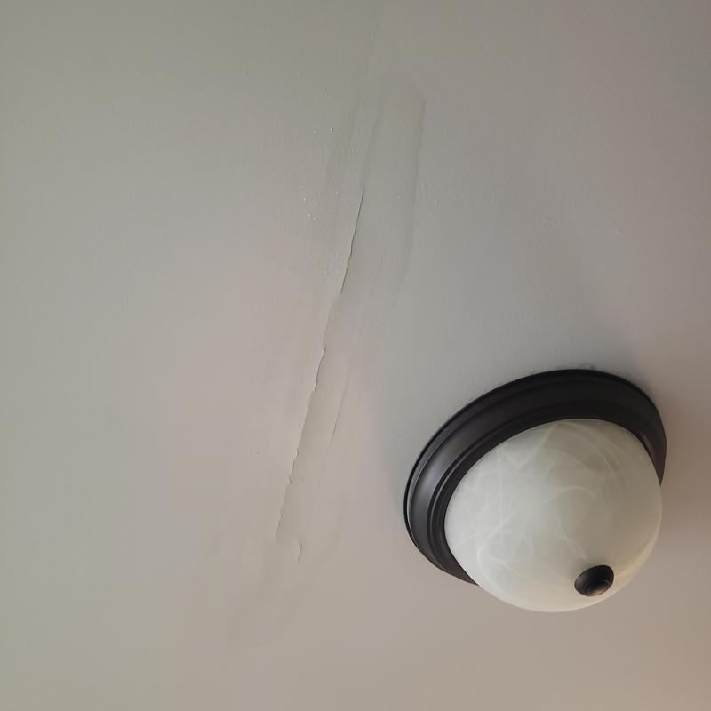 Ceiling drywall water damage near light fixture