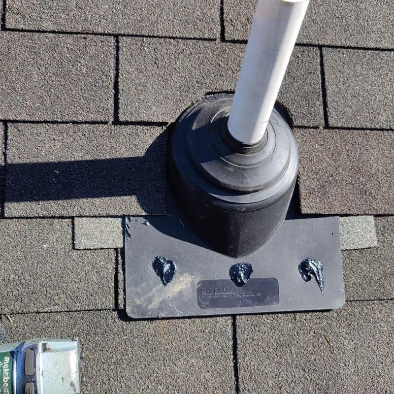 Pipe boot on asphalt shingle roof with caulked seals