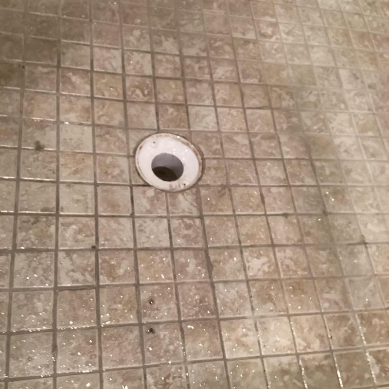 Shower drain opening on tiled shower floor