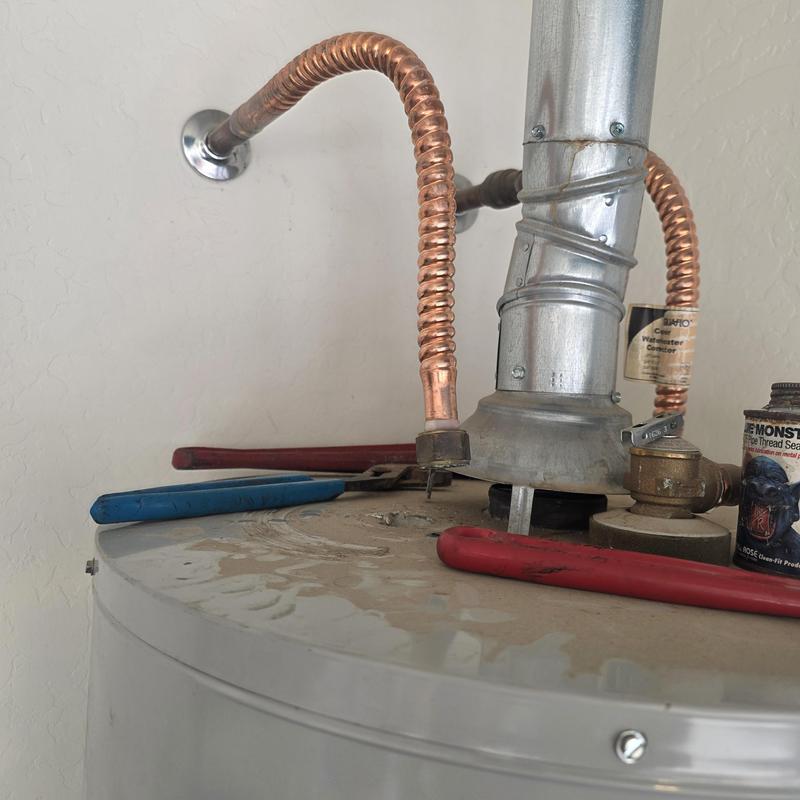 Water heater with copper pipes and tools on top