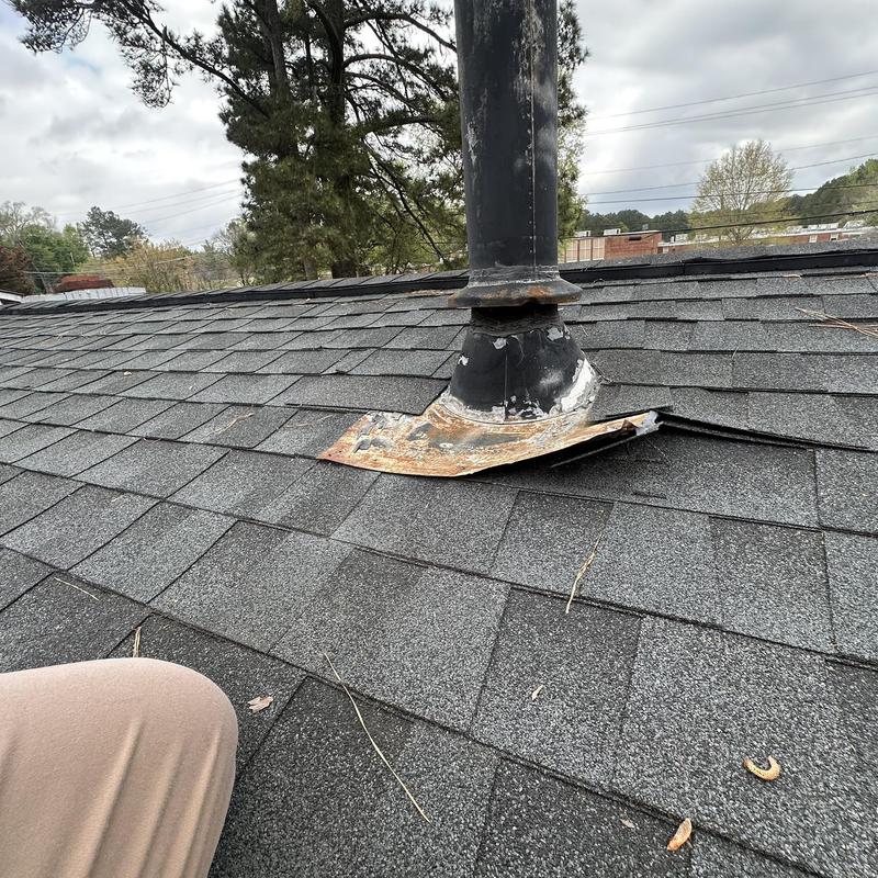 Roof vent flange lifted with rusted flashing on shingles