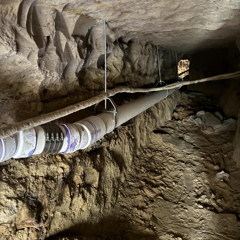 PVC sewer pipe installed in underground tunnel trench