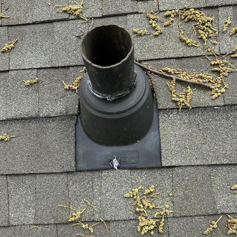 Roof vent pipe with deteriorating sealant and debris