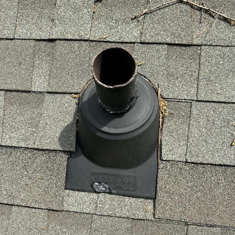 Roof vent pipe with deteriorating sealant and shingle wear