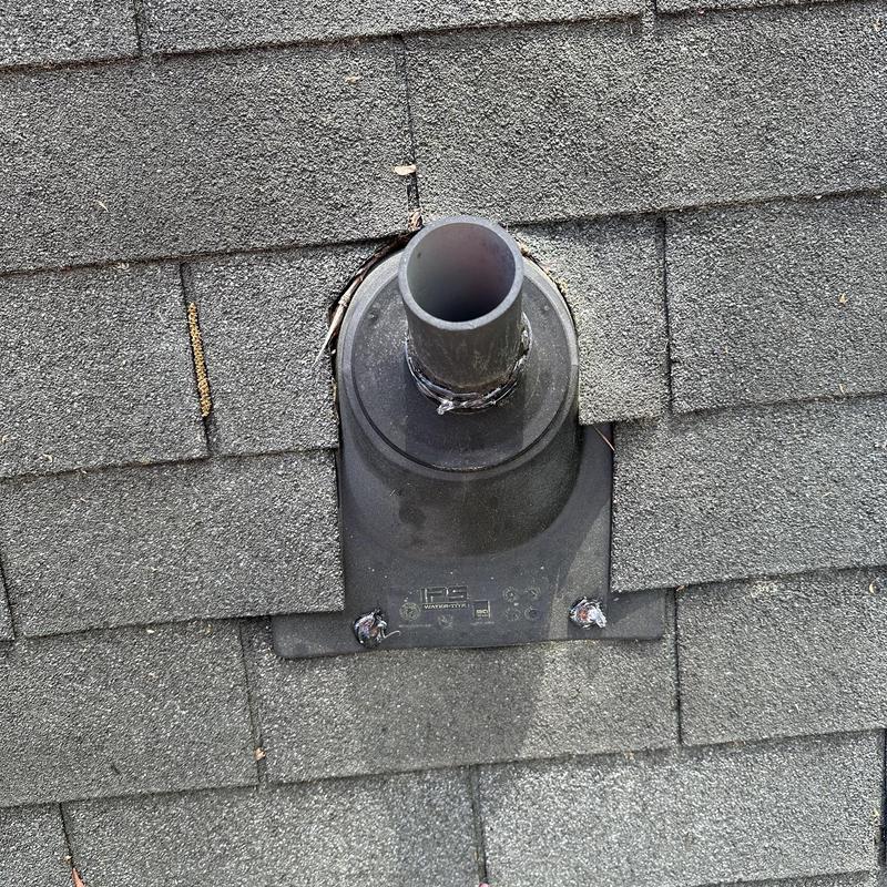 Roof vent pipe flashing with sealant on shingles