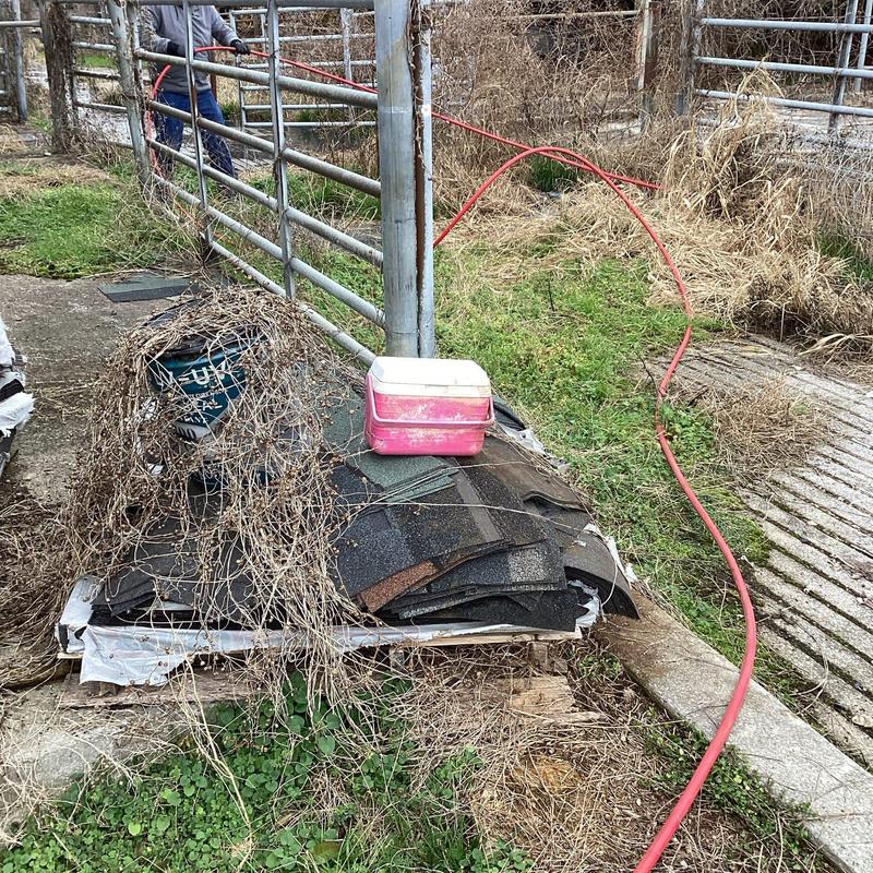 Drain line jetting hose extending through fence gate
