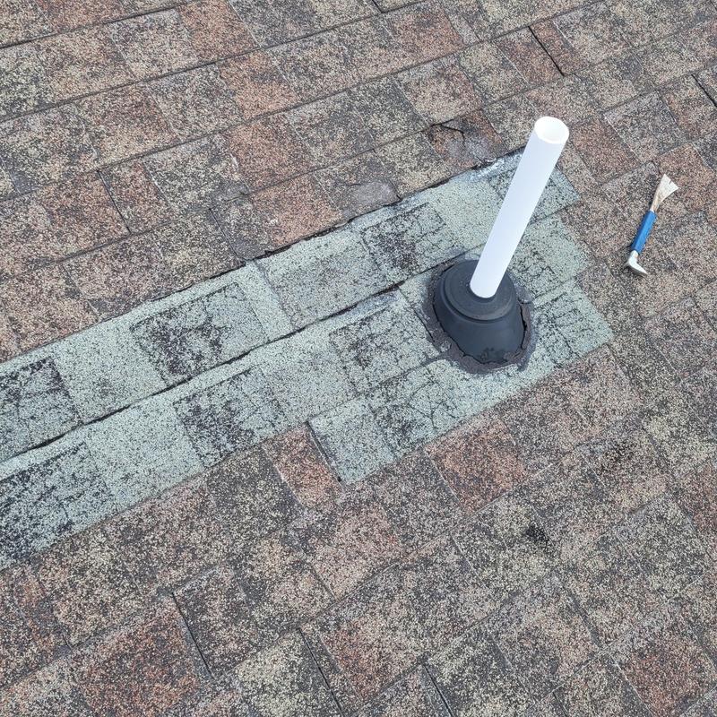 Roof vent pipe flashing with temporary patch on shingles