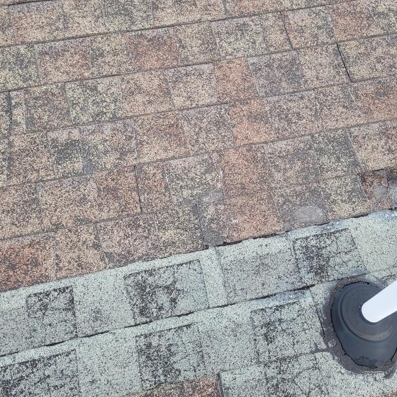 Roof shingles showing wear and temporary seal around vent pipe