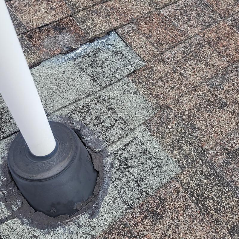 Roof shingle damage around vent pipe flashing seal
