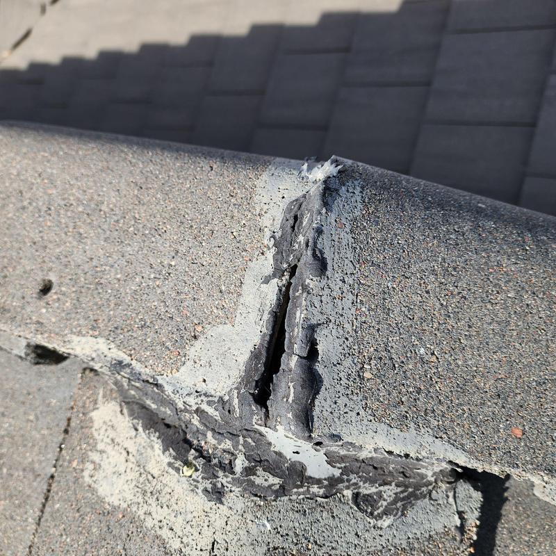 Tile roof ridge with cracked sealant and damage Tile roof ridge with cracked sealant and damage