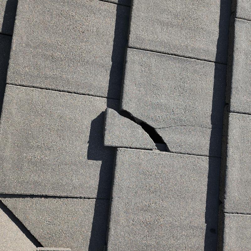 Concrete tile with visible crack and break damage Concrete tile with visible crack and break damage