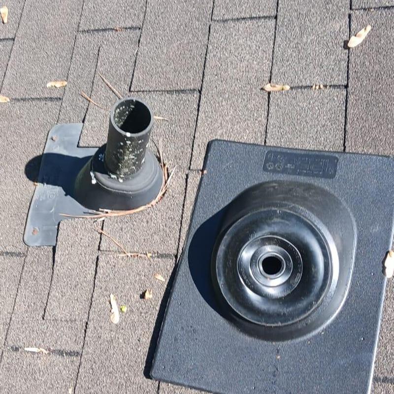 Pipe boots on shingled roof with one replaced boot