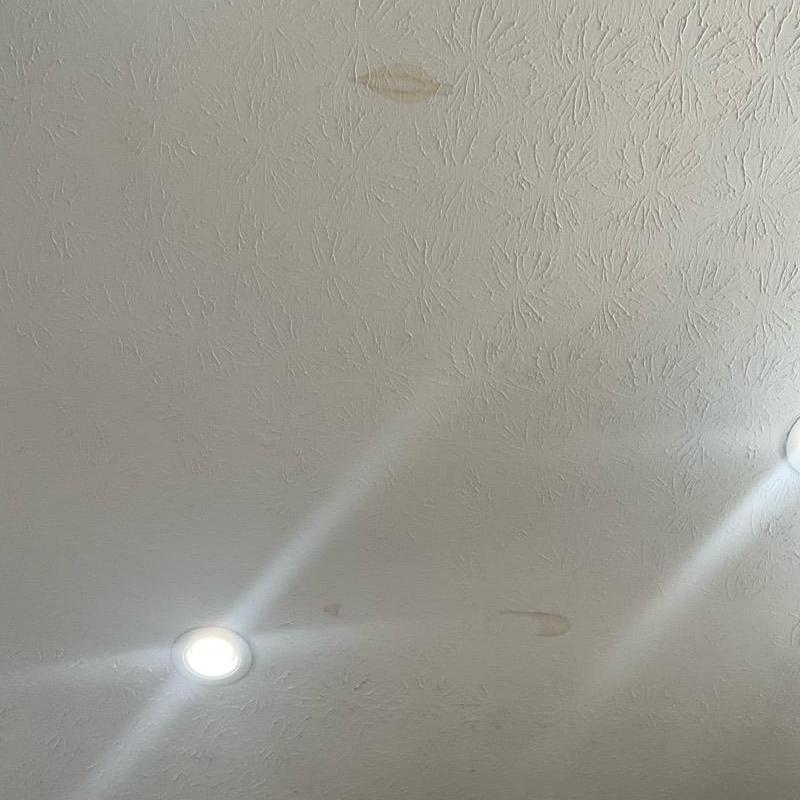 Ceiling with water stains from roof nail pop